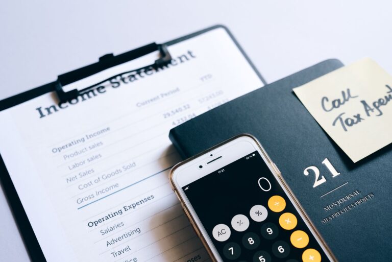 Income statement, calculator, and planner on a desk