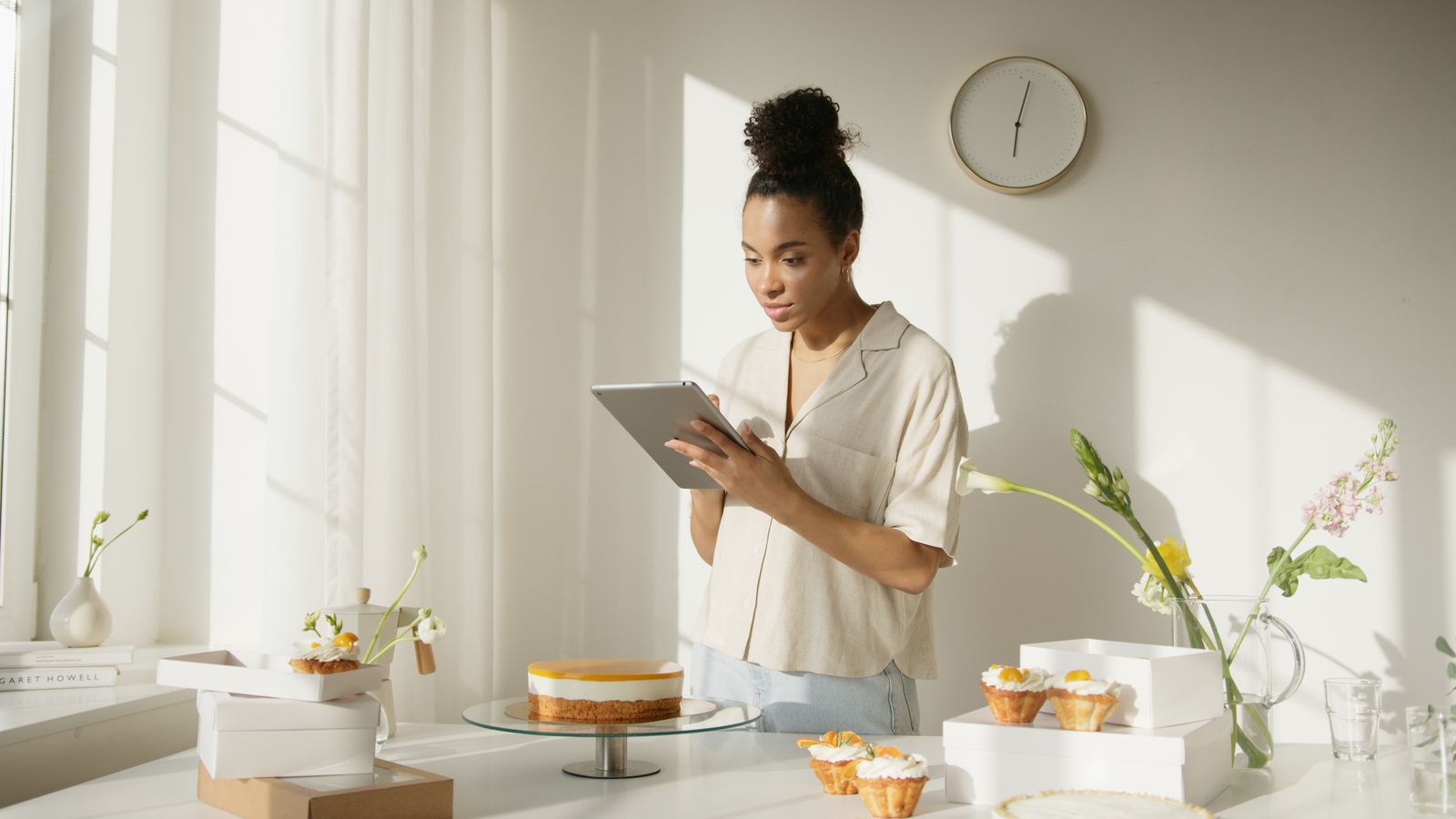 Small bakery owner reviewing orders on a tablet