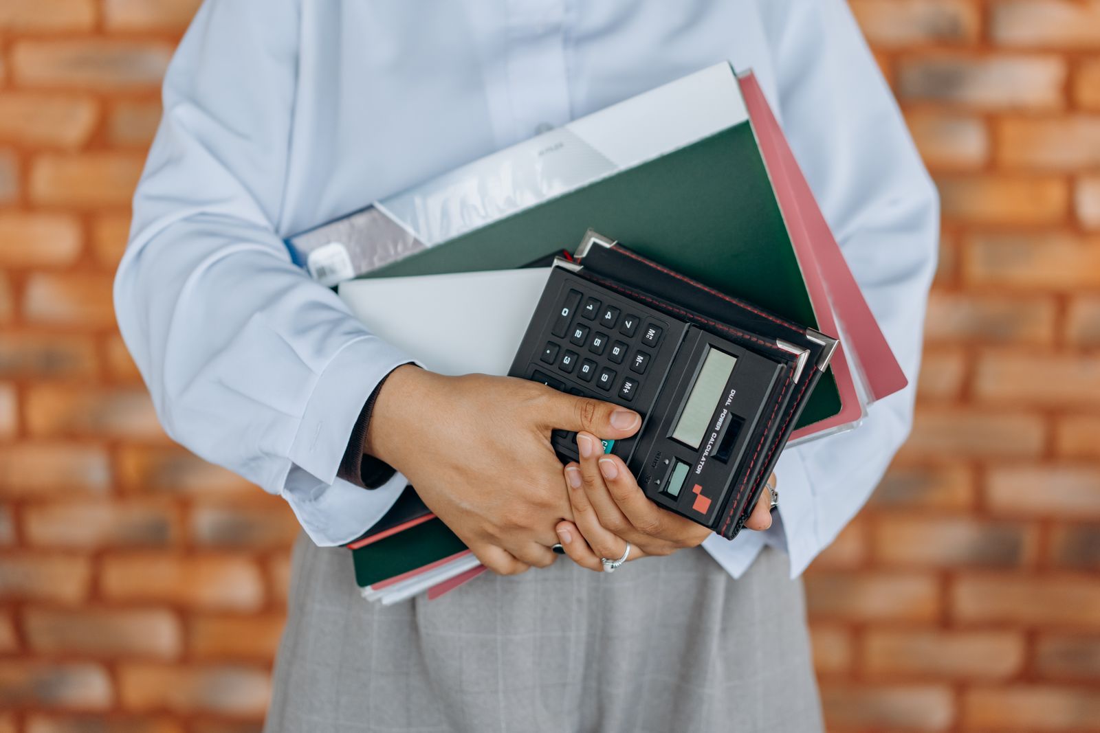 Bookkeeper at work with a calculator and paperwork