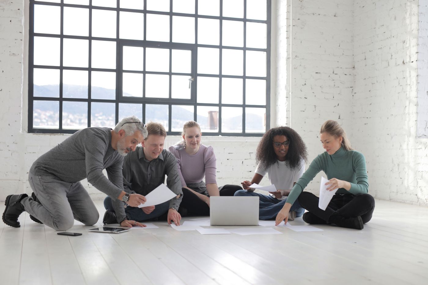 A diverse group of professionals collaborating in a light-filled workspace
