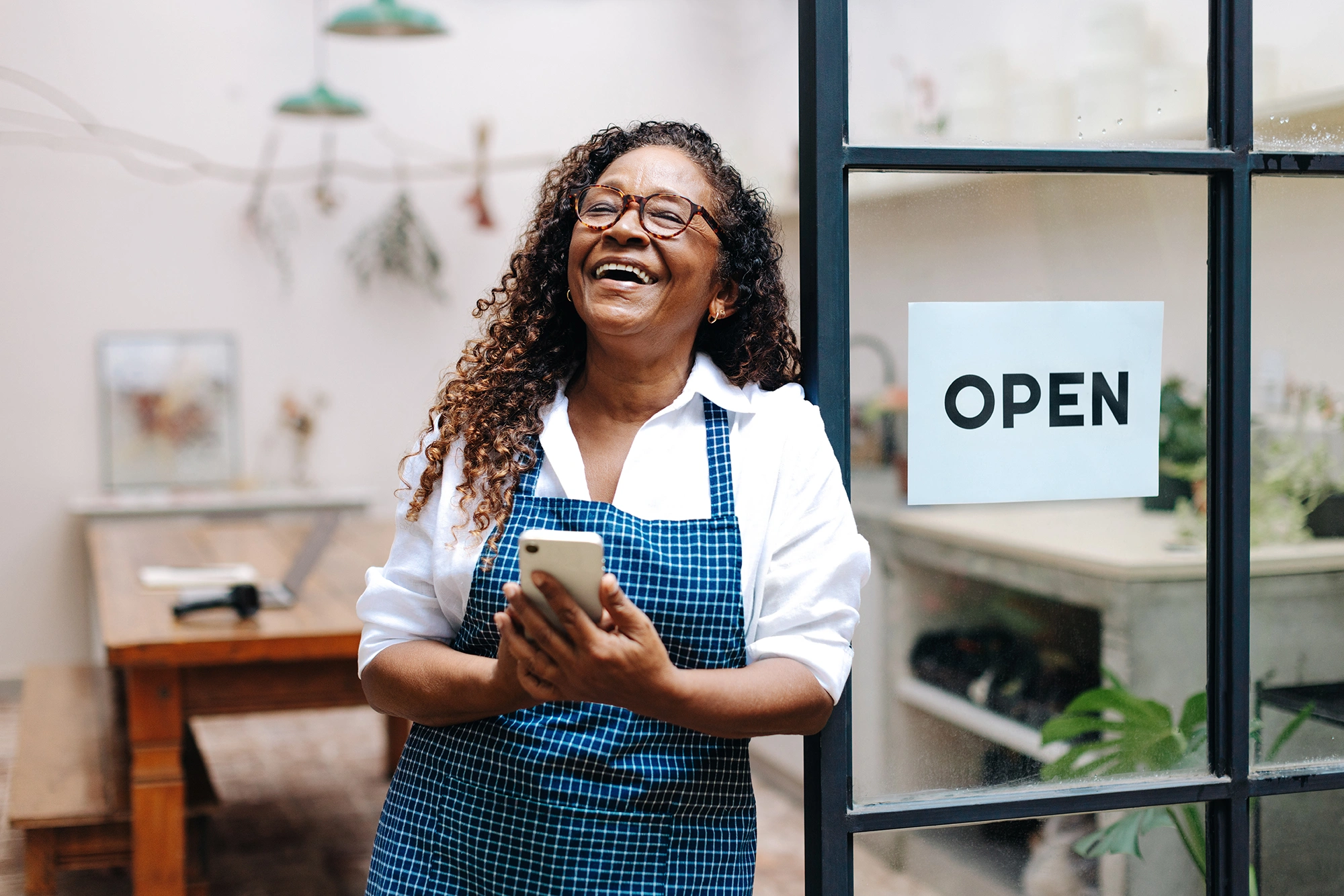 A small business owner smiling in her shop