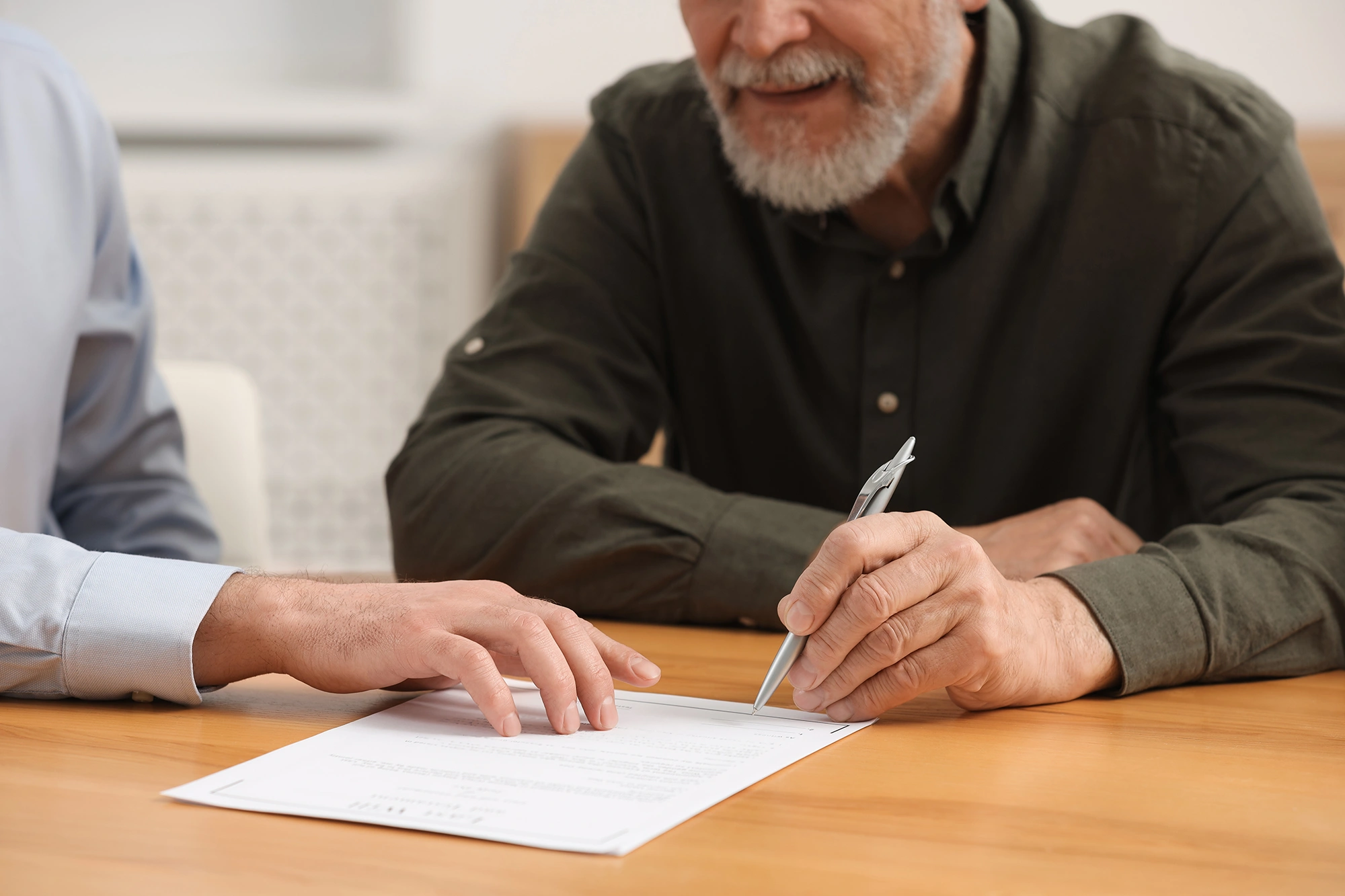 A notary guiding a client through signing a document